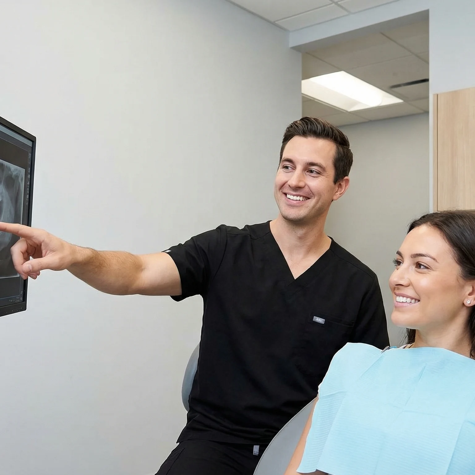 Dentist showing patient dental x-ray on monitor explaining preventive care and early detection Dalton GA