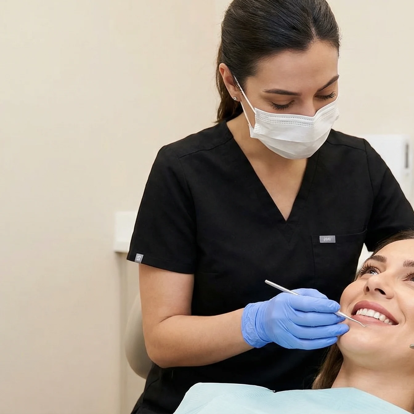 Professional dentist in black scrubs examining patient's healthy smile in Dalton GA dental office